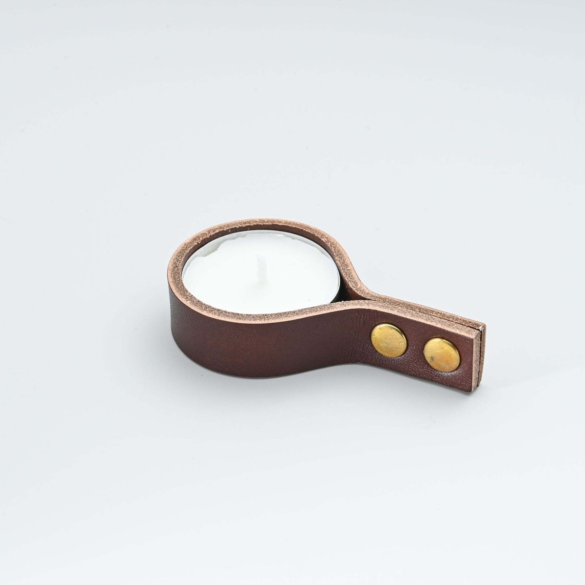 Minimalist brown leather candle holder for tealight candles with straight ends and brass snaps